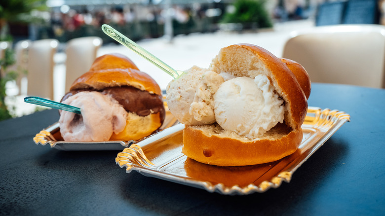 brioche con gelato on silver platters with spoons