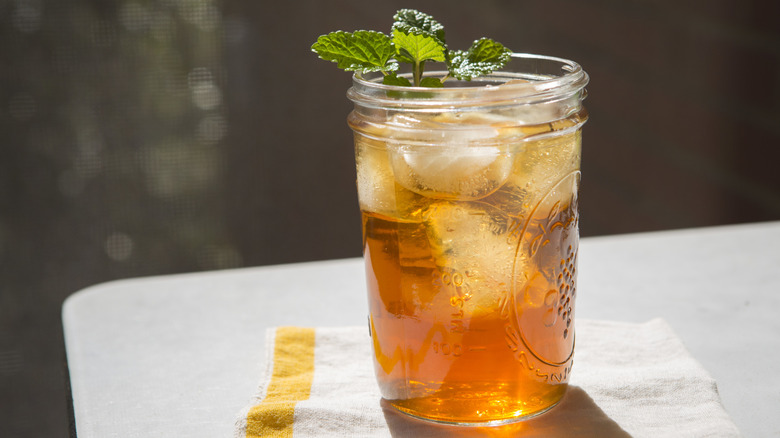 A mason jar glass with iced tea