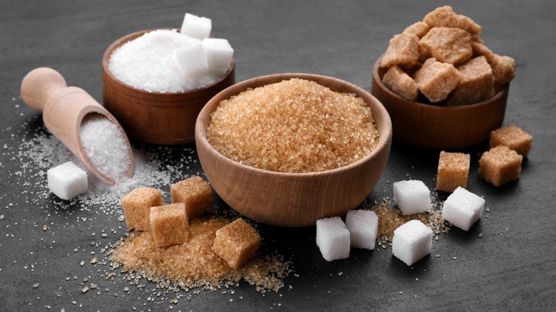 Different types of sugar on a black table