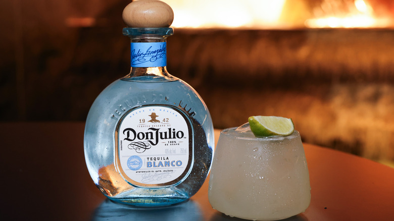 Bottle of Don Julio tequila blanco next to tequila cocktial