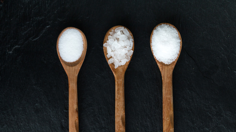 three different salts in wooden spoons 