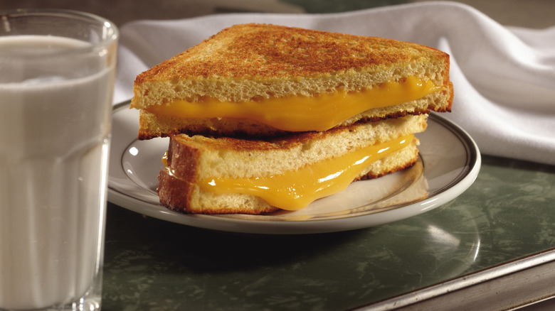 Grilled cheese beside a glass of milk