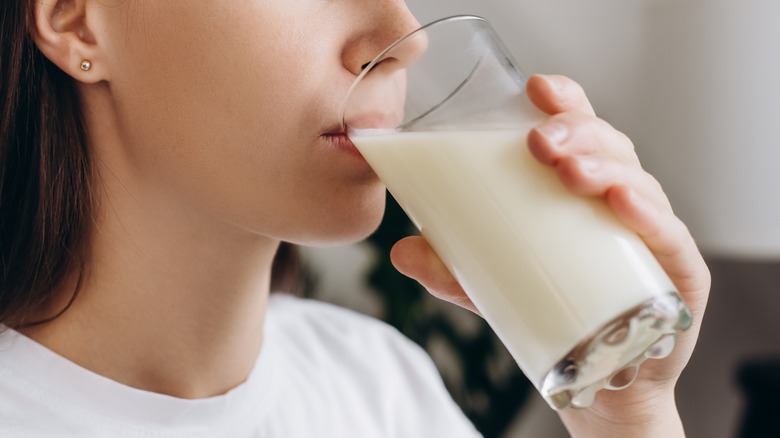 A woman drinking a glass of milk