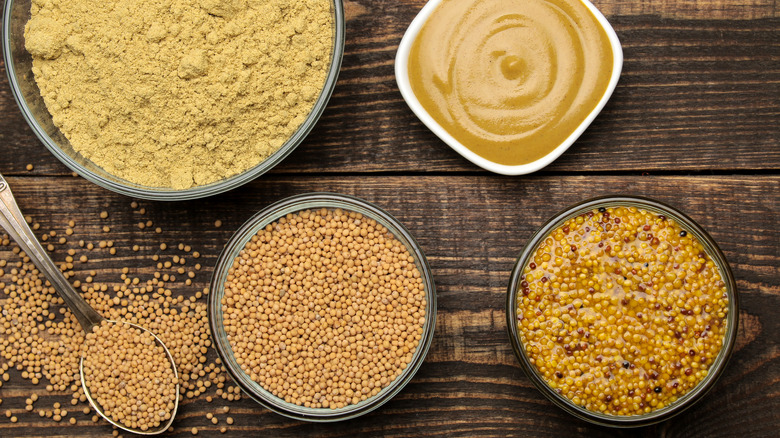 Different types of mustard in bowls