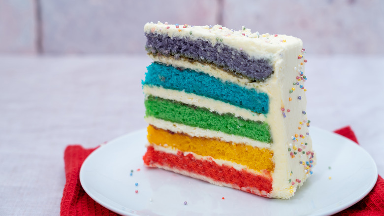 slice of rainbow layer cake