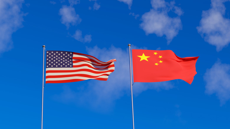 U.S flag and Chinese flags on a sky backdrop