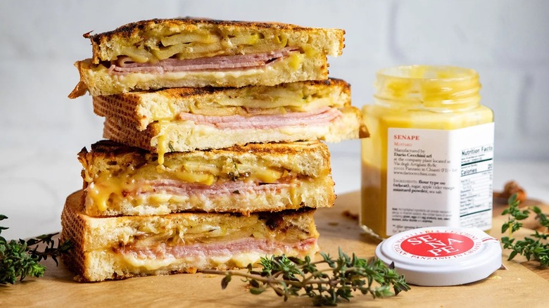 Jar of Dario Cecchini mustard and pile of paninis