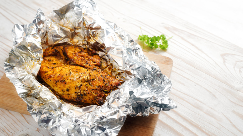 Chicken breast in aluminum foil.