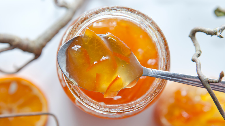 A spoon and a jar of orange marmalade
