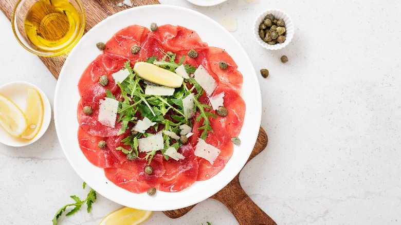 Beef carpaccio with lemon and other ingredients