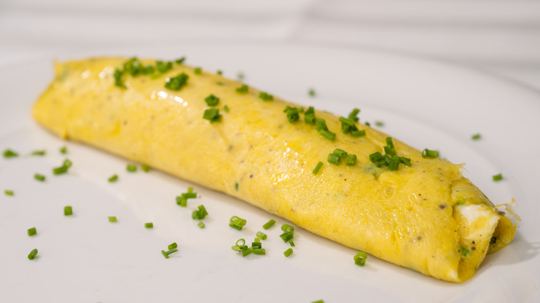 french omelette on plate with chives