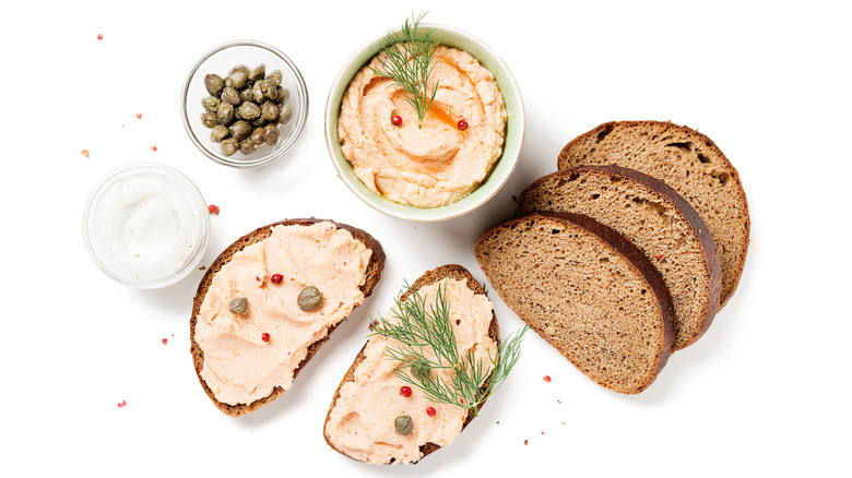 Salmon pate spread on dark bread with capers