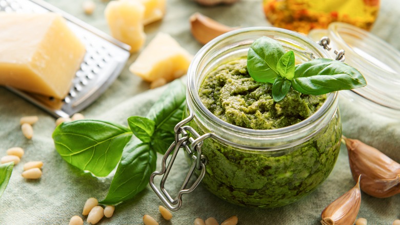 jar of pesto with fresh ingredients