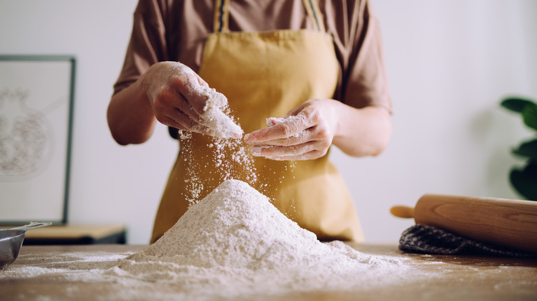 Baker using heap of flour