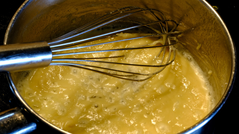 Whisking butter and flour to make a roux