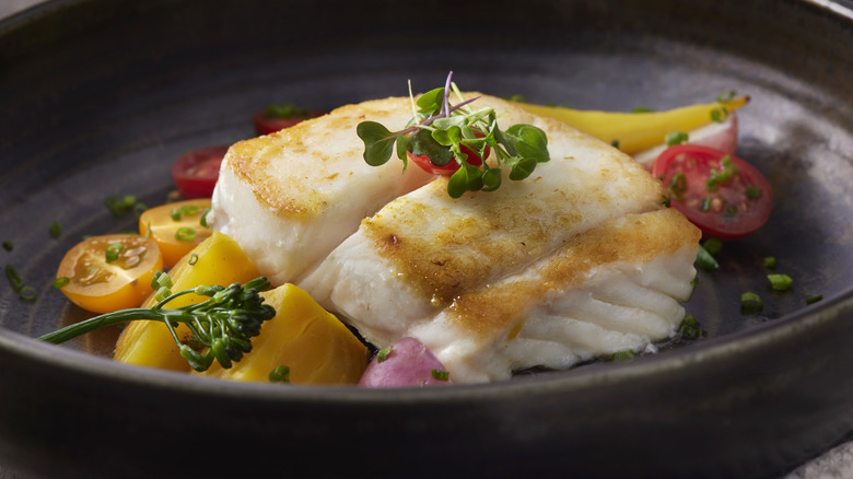 Cooked halibut in dish with vegetables