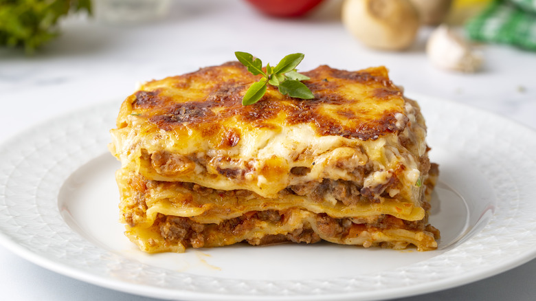 Square of lasagna on white plate