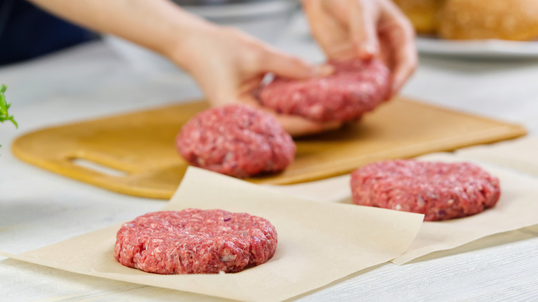 Person forming burger patties by hand