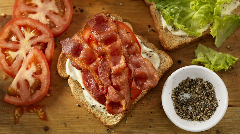 Open BLT sandwich with bacon, tomato, lettuce, mayo, and pepper