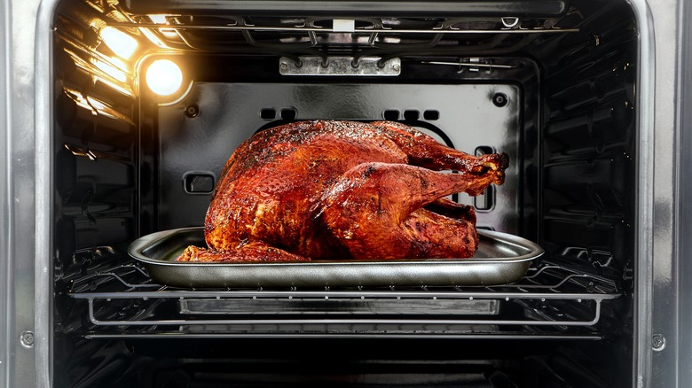 A whole turkey roasting in the oven