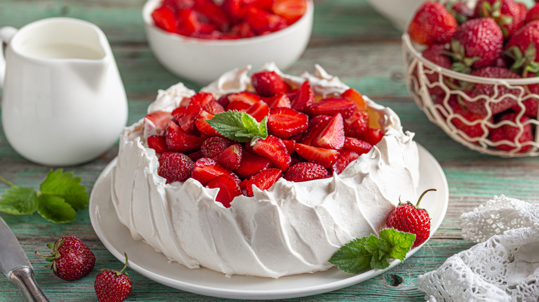 A fruit pavlova with strawberries and mint.