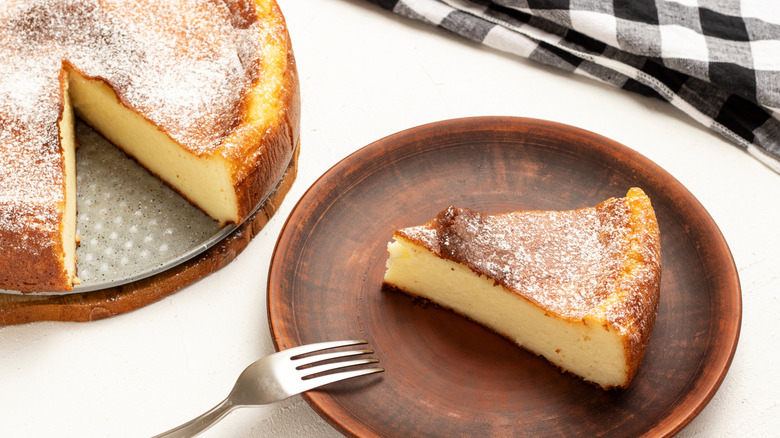 A slice of migliaccio cake on a wooden plate