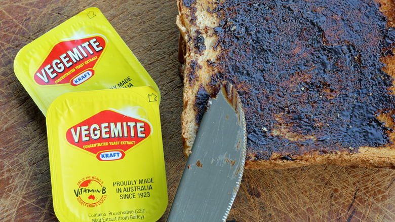 Vegemite packs next to toasted bread with vegemite