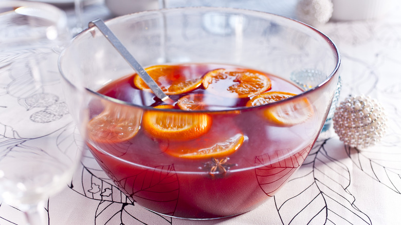 Glass bowl of Christmas punch with oranges on a table