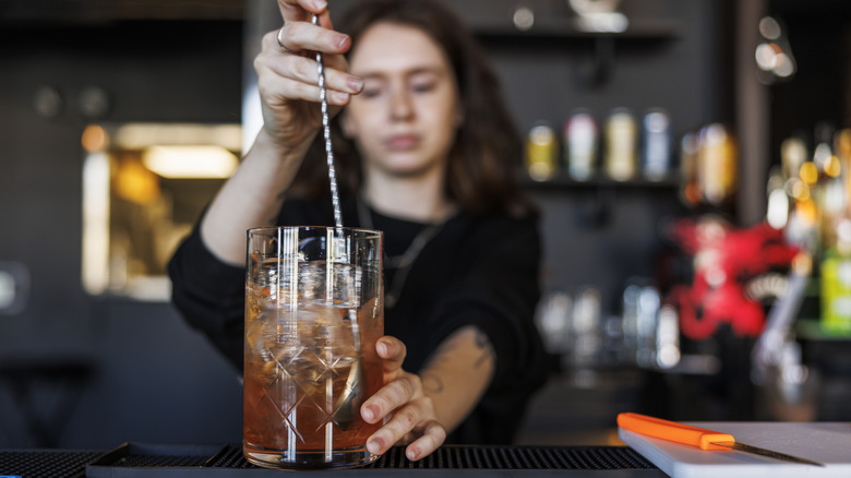 Bartender stirring cocktail