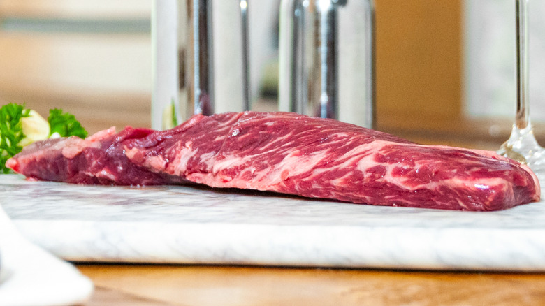 Raw hanger steak on marble slab