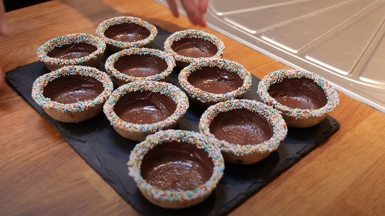 Cookie cups with chocolate and sprinkes