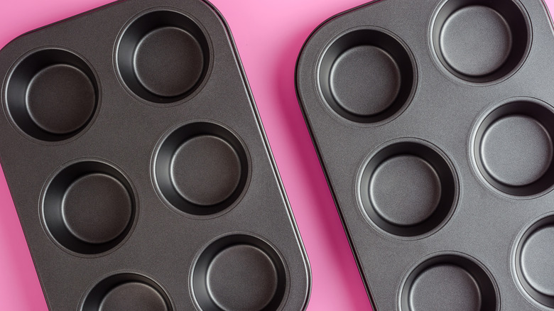 muffin tins on pink background