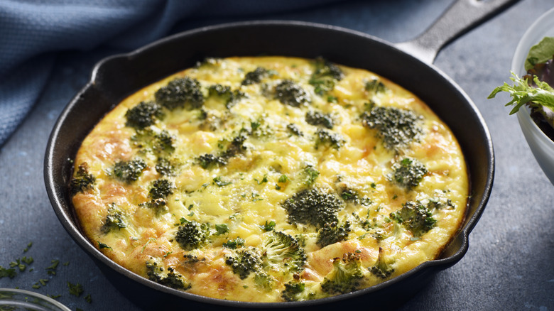 Frittata in skillet with broccoli