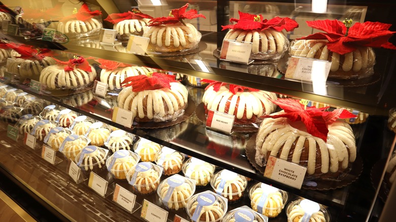 A Nothing Bundt Cakes display case with holiday cakes and mini bundts individually wrapped