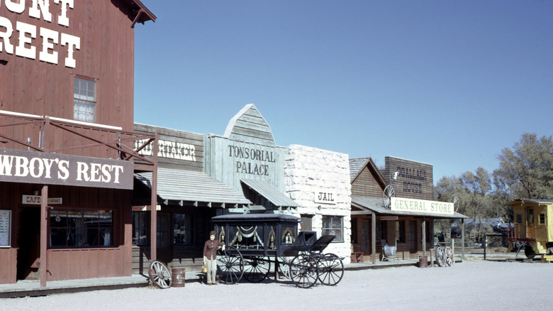 Sepia filtered image of the front of Front Steet Steakhouse complex with Old West style General Store, jail structure, playhouse, cafe, and Crystal Palace Saloon