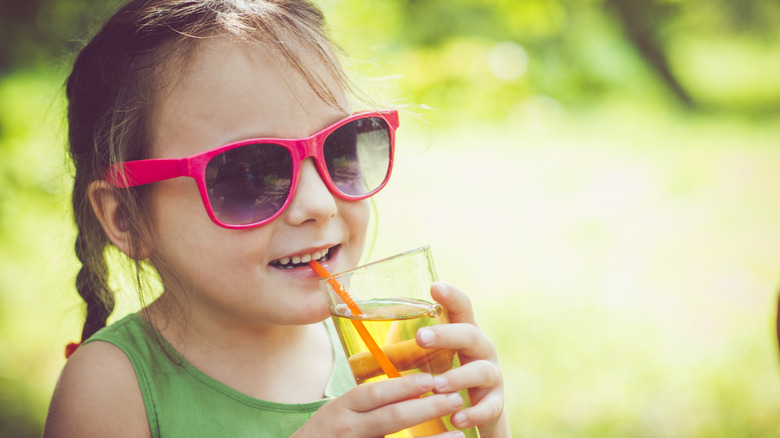 Girl drinking apple juice