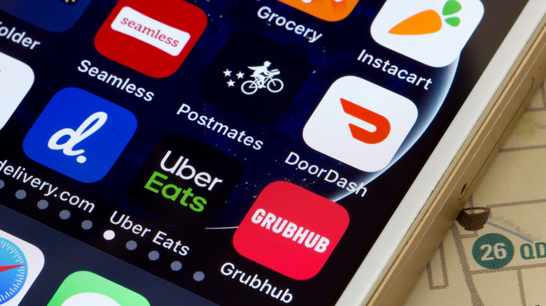 Close up of smartphone screen with food delivery app icons