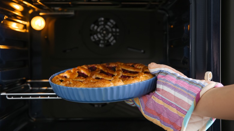 taking pie out of oven