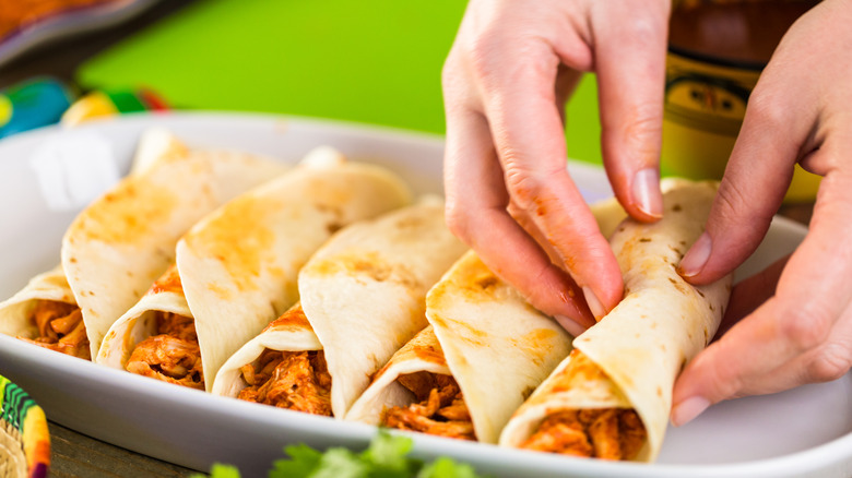 Chicken enchiladas rolled by hand