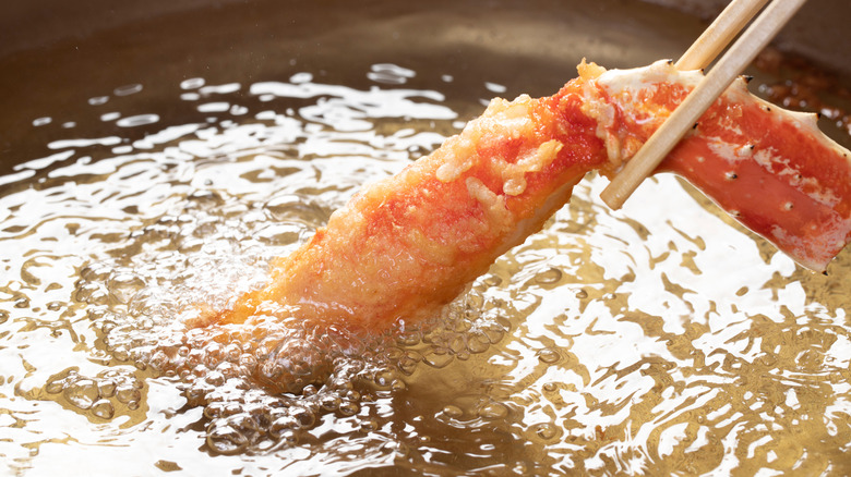 Tempura being dipped in oil