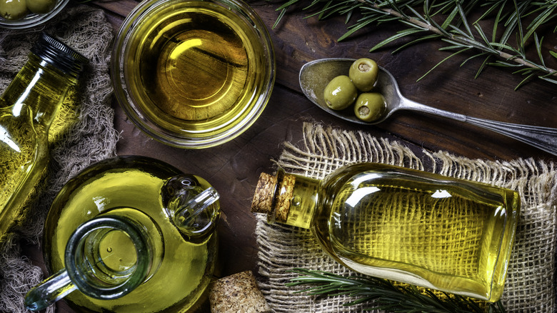 several bottles of olive oil and olives