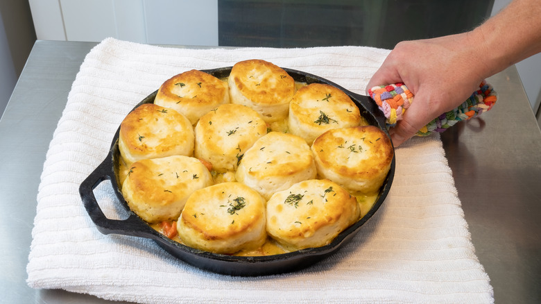 Pot pie in cast iron skillet topped with biscuits