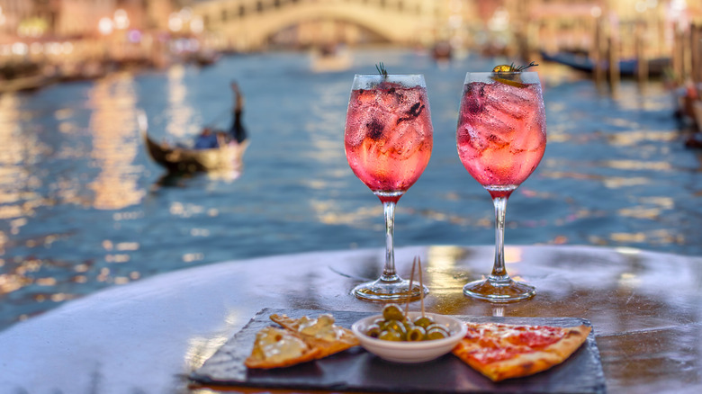 Pink beverages and appetizers with the Grand Canal in Venice in the background