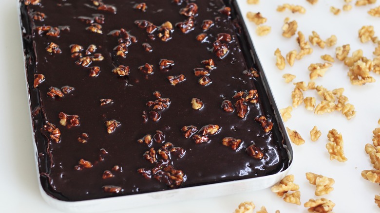 Chocolate Texas sheet pan cake with scattered walnuts