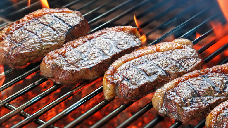 picanha steaks over charcoal grill