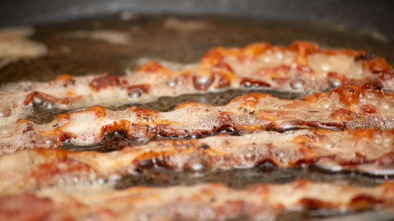 Bacon sizzling in frying pan