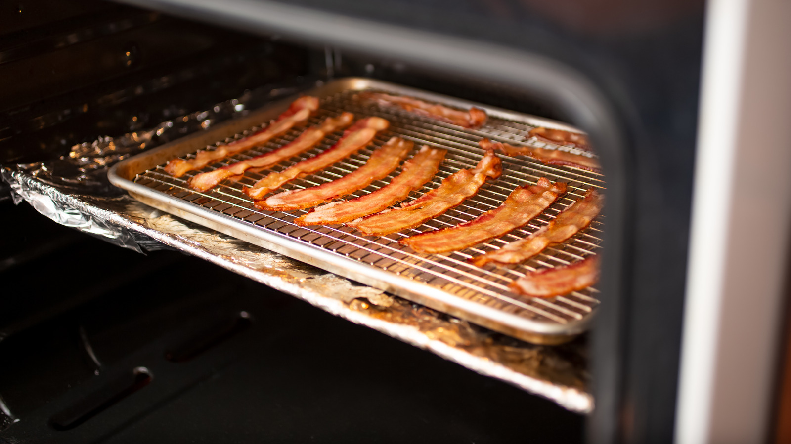 https://www.foodrepublic.com/img/gallery/the-one-step-that-will-stop-bacon-from-sticking-to-your-oven-rack/l-intro-1701447028.jpg