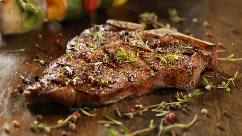 Porterhouse steak garnished with herbs