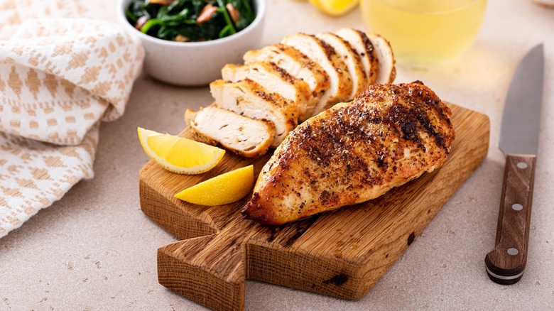 Sliced grilled chicken on cutting board