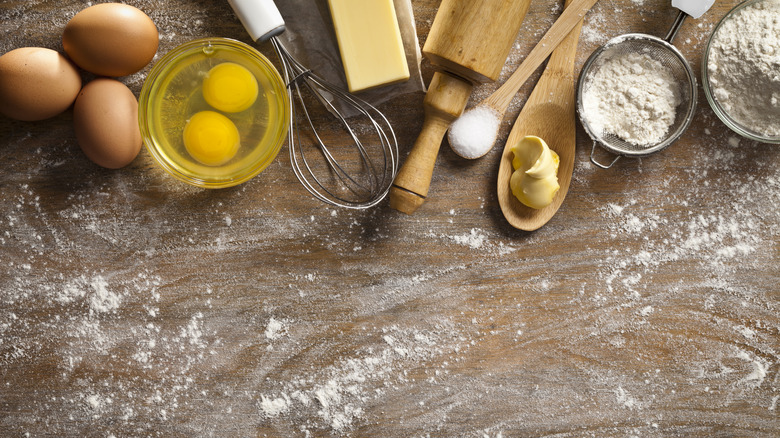 Eggs, butter, sugar, and flour on a counter